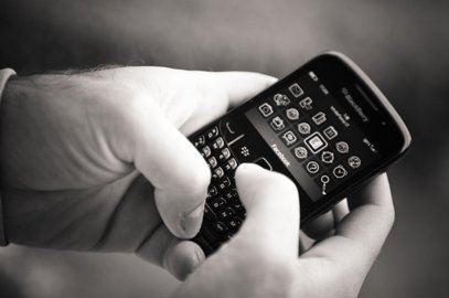 Closeup of a person using a Blackberry mobile device