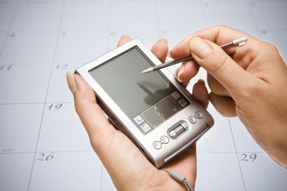 Closeup of a person using a Personal Digital Assistant (PDA)