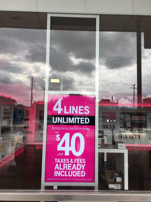 T-Mobile promotional poster on the glass window of a store